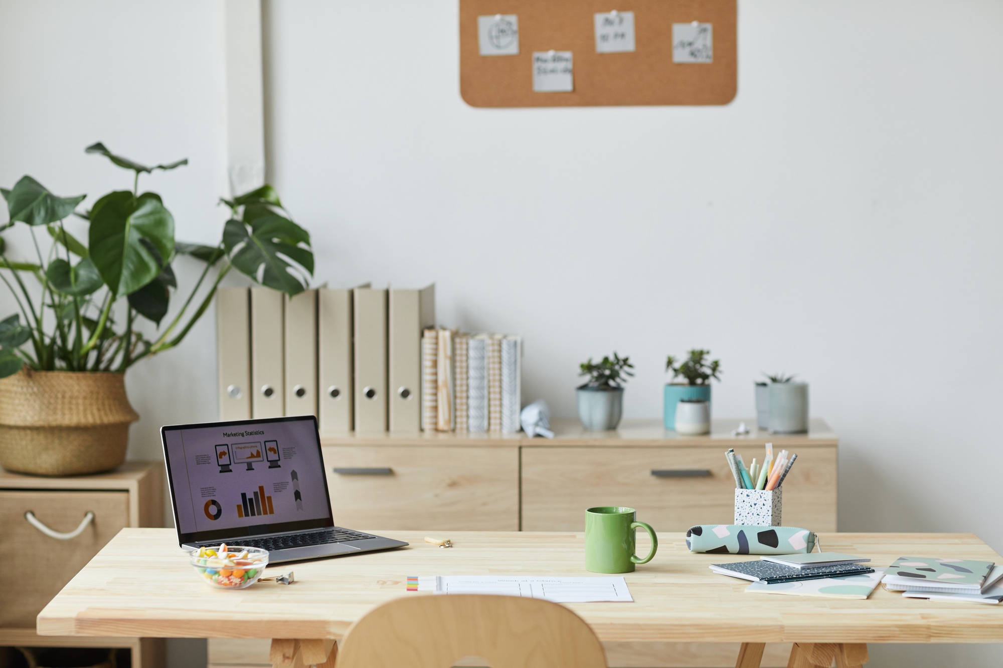 Cozy home office with a comfortable desk, ergonomic chair, soft lighting, and personal touches like plants and artwork, creating a productive yet relaxing environment