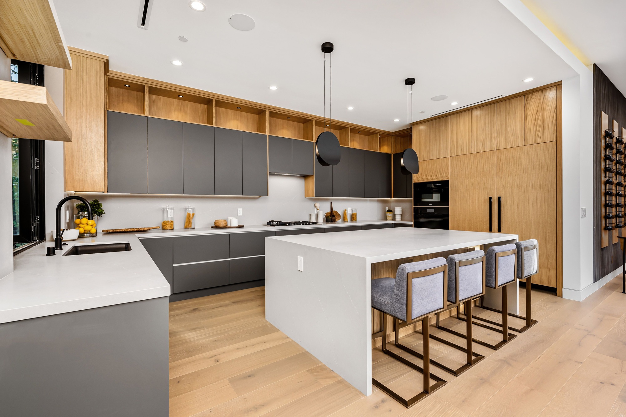 Modern kitchen interior with a large island and sleek cabinetry.