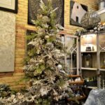 Cozy living room adorned with elegant Christmas holiday decorations, including twinkling lights, bells, and seasonal ornaments