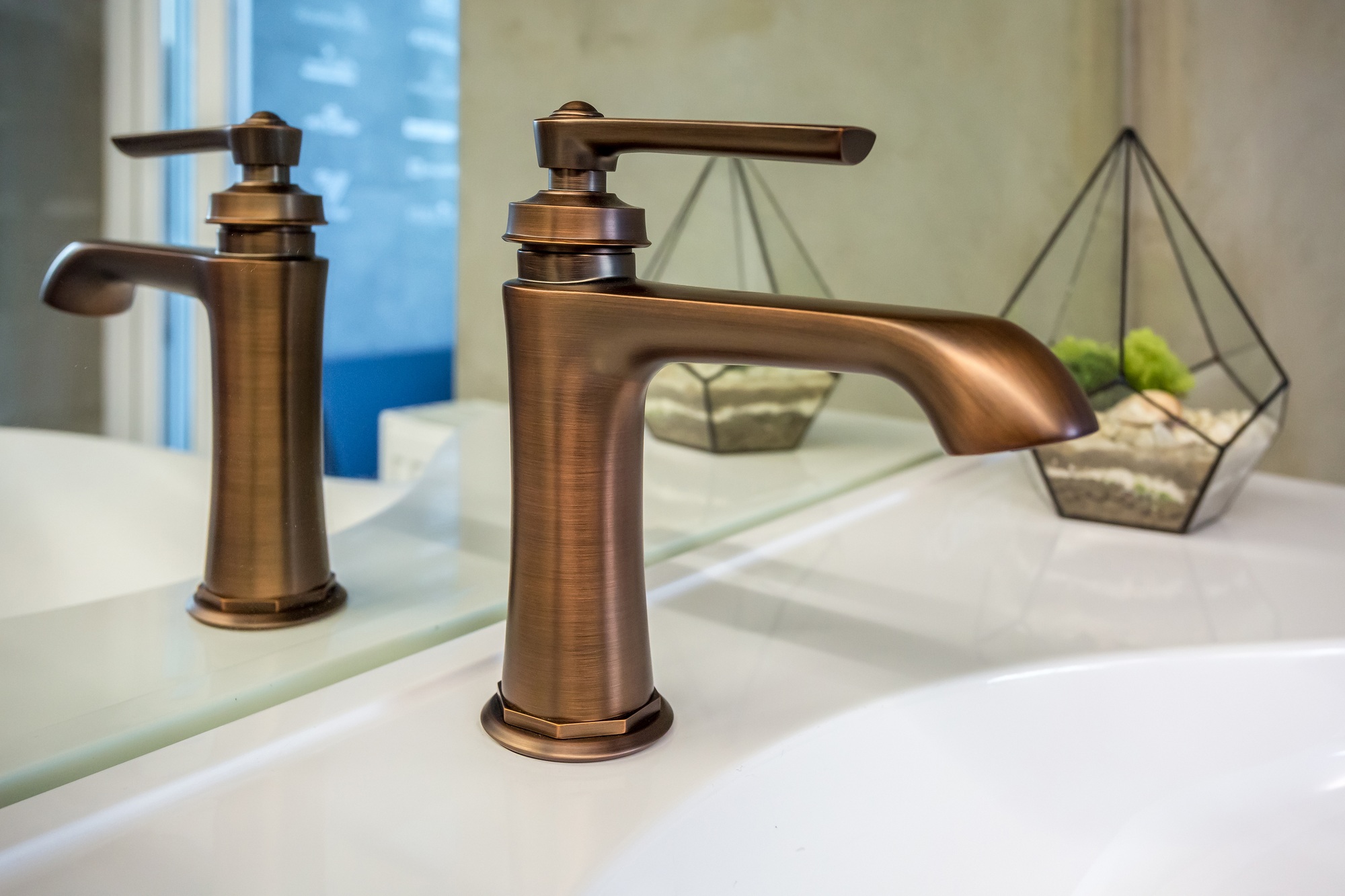 Elegant loft bathroom showcasing a copper water tap and matching faucet over a modern sink, blending luxury and industrial design elements