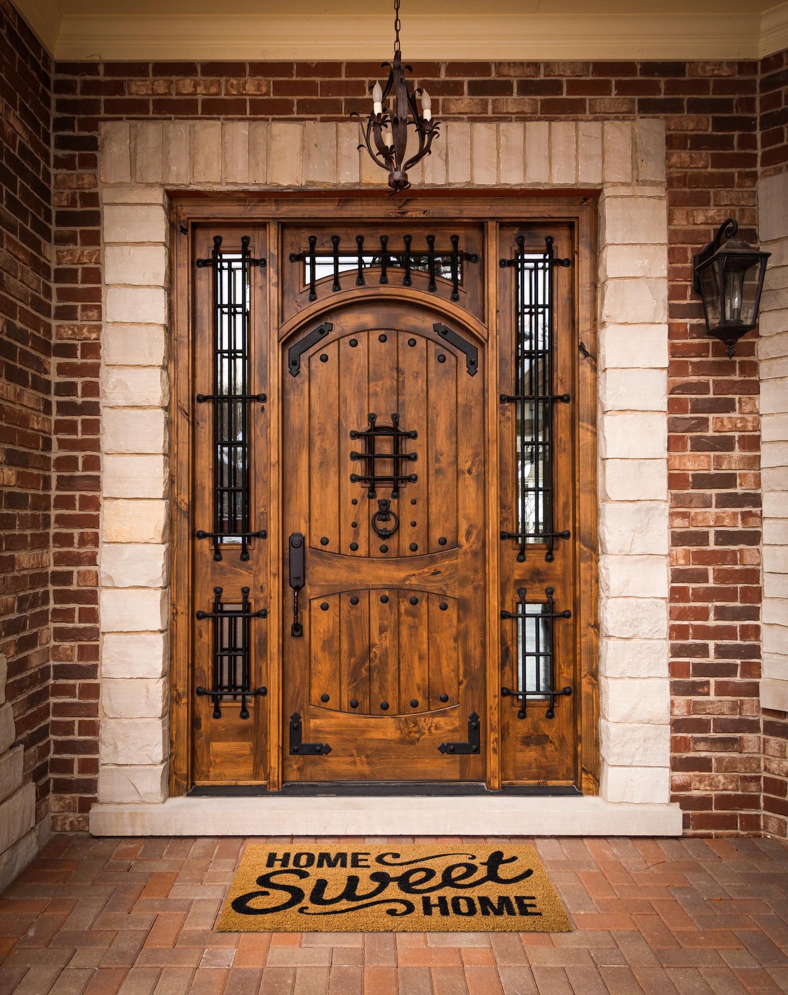A custom front door with a 'Home Sweet Home' welcome mat, showcasing Meraki Builder’s attention to personalized exterior details