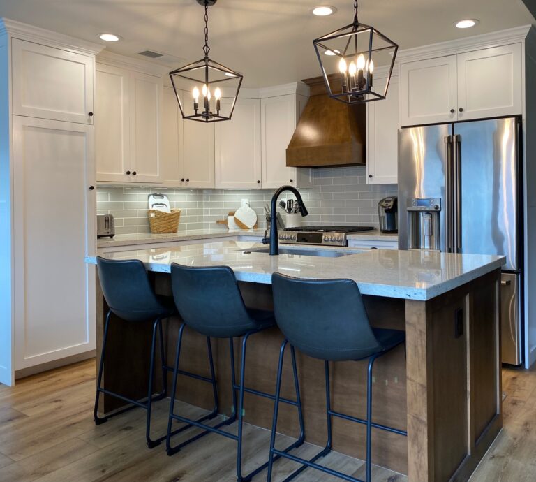 Charming small farmhouse kitchen remodeled by Meraki Builder, featuring white cabinets, granite countertops, and stylish pendant lighting