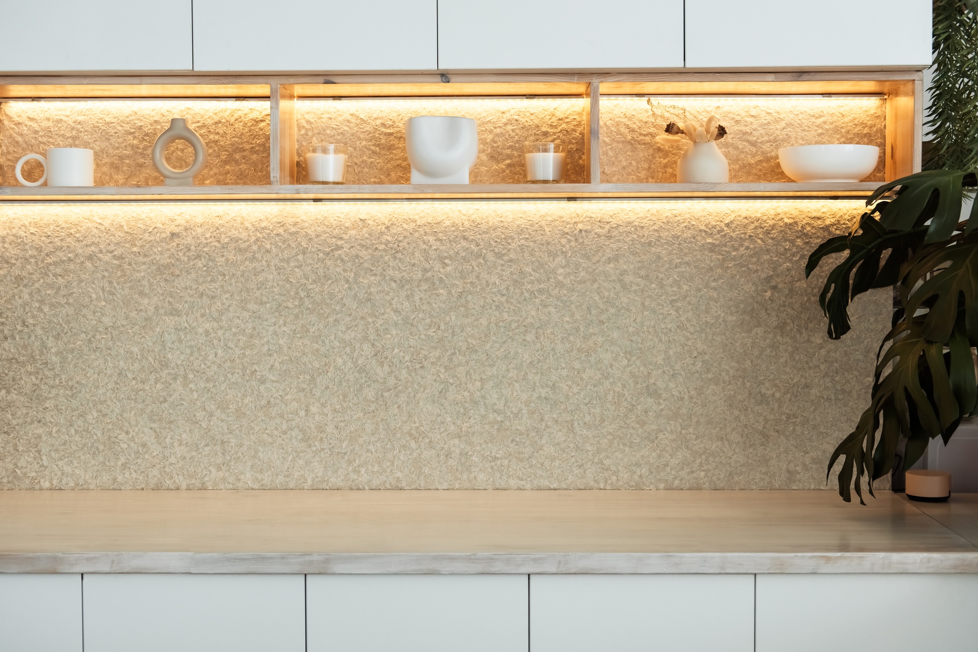 Stylish kitchen interior with modern cabinets and wooden countertop lights in a luxury new house.