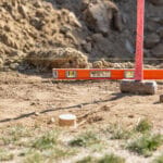 Custom home building site prepared with survey stakes before construction begins.