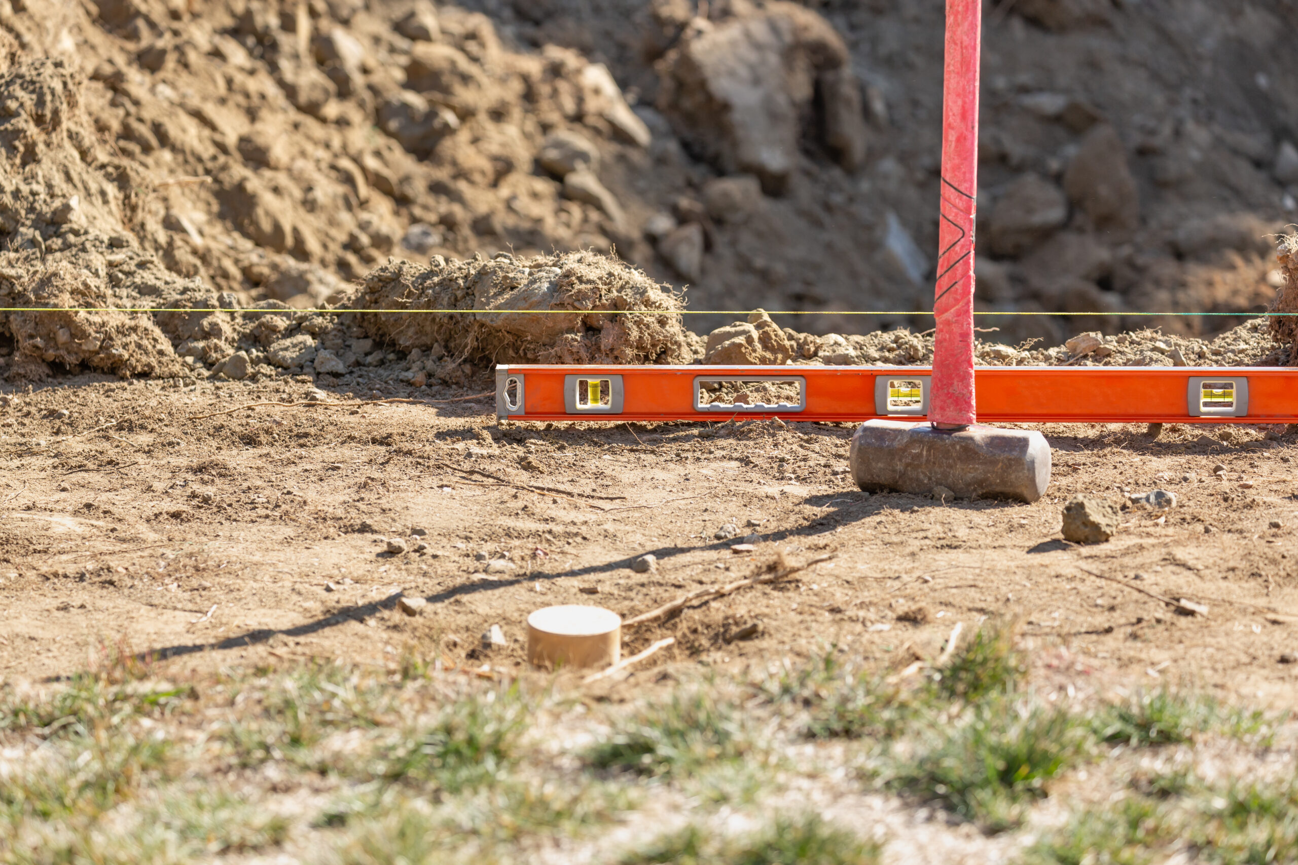 Custom home building site prepared with survey stakes before construction begins.