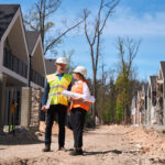 Builder and homeowner evaluating a homesite before building a custom home.