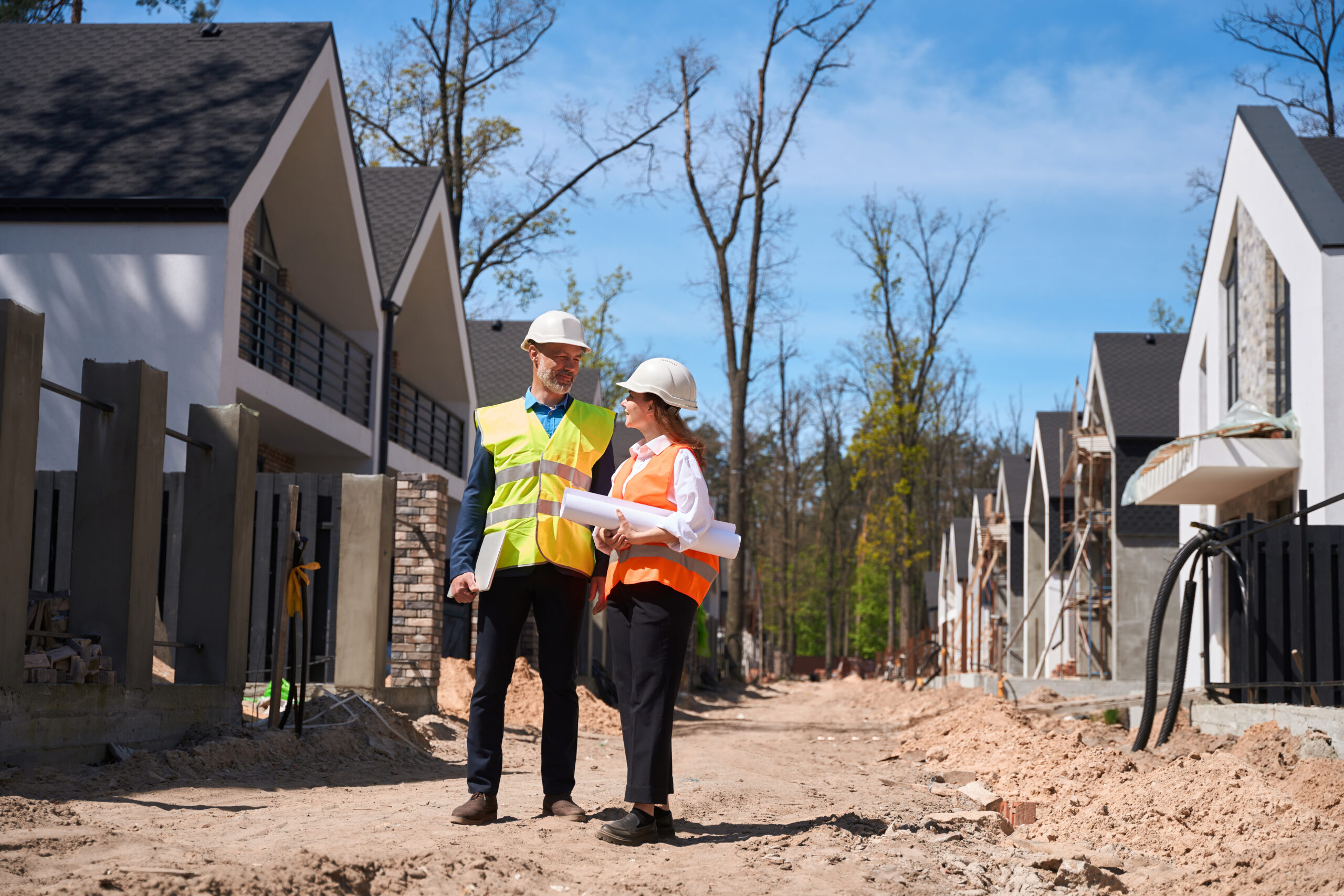 Builder and homeowner evaluating a homesite before building a custom home.
