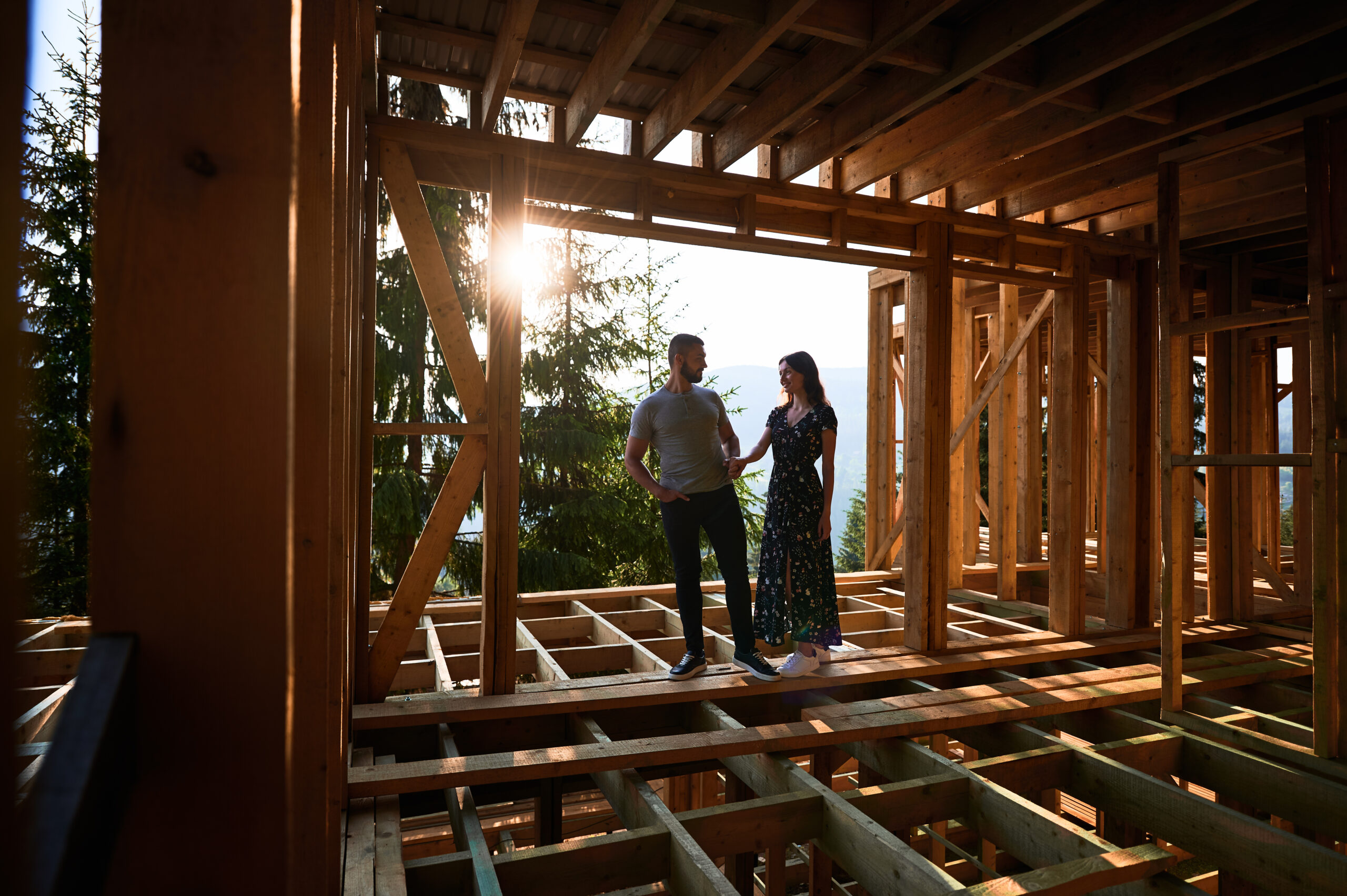 Future homeowners planning a custom home build with their builder on an empty lot.