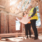 Homeowner and custom home builder reviewing construction plans before building begins.