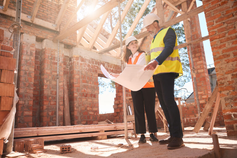 Homeowner and custom home builder reviewing construction plans before building begins.