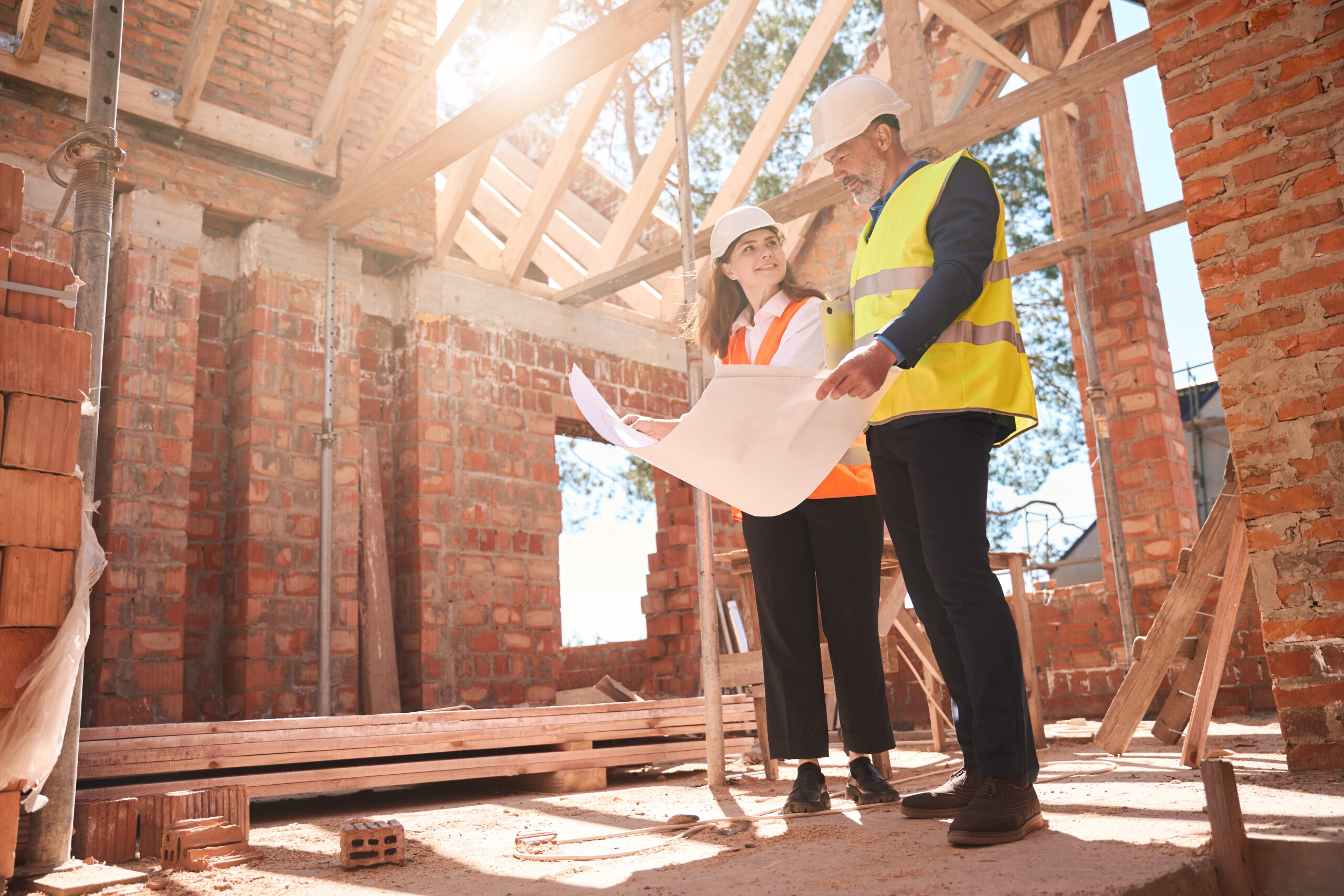Homeowner and custom home builder reviewing construction plans before building begins.